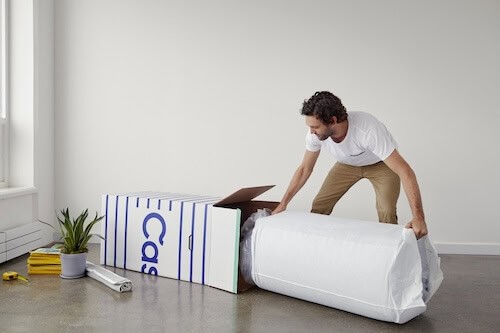 Man unpacking mattress