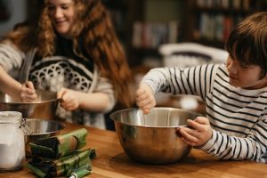 Kids preparing dinner together in a kitchen