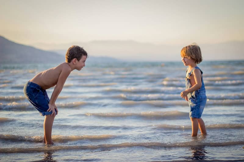 Two boys playing on the beach