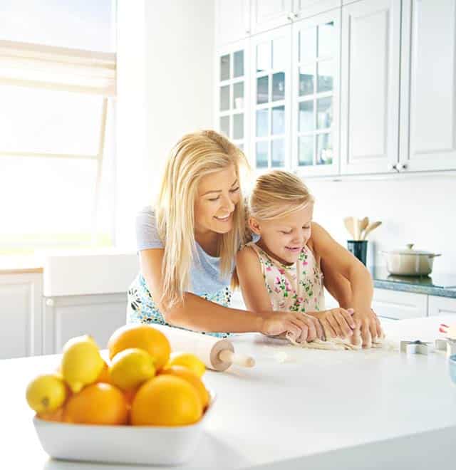 Mother and daugher baking in clean, organized kitchen