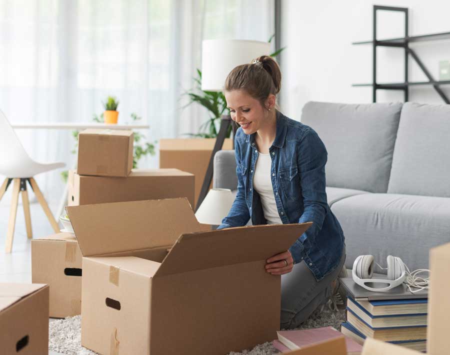 Woman unpacking a box with Perfectly Placed professional organizers St. Louis.