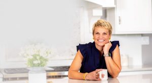 Professional Organizer Susan Stewart sitting at clean, organized kitchen counter