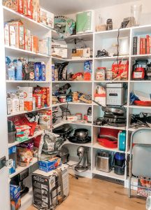 Cluttered pantry shelves which need organizing