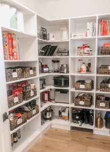 Kitchen pantry organized with containers and shelves
