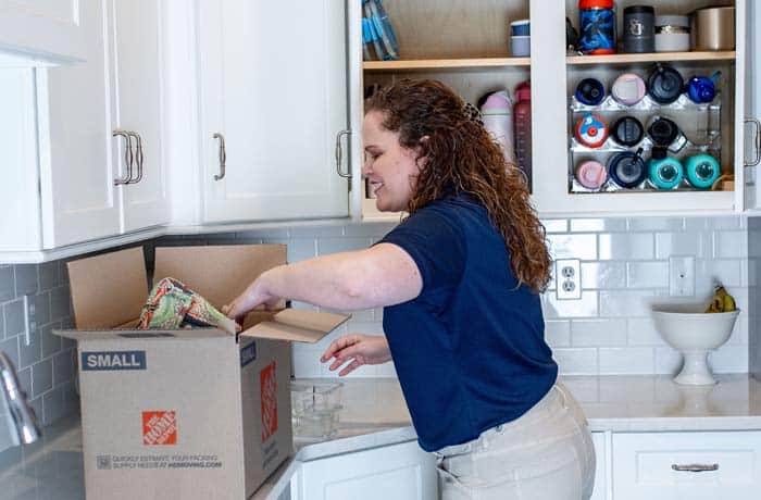 One of St. Louis' top ranked professional organizers unpacking a box in a kitchen