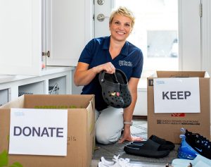 Expert St. Louis-based home organizer Susan Stewart sorting through boxes